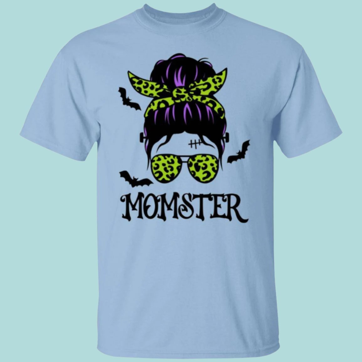 Momster Halloween T-Shirt in light blue with an image of a hip-looking featureless faced woman. She has a scar and stitches on her forehead with bolts on each side of her neck like Frankenstein. Her purple hair is in a messy bun tied with a lime green leopard patterned bandana, which matches her printed ray-ban sunglasses. Flying around her head are bats. MOMSTER is printed beneath the image. - Any Gift For You