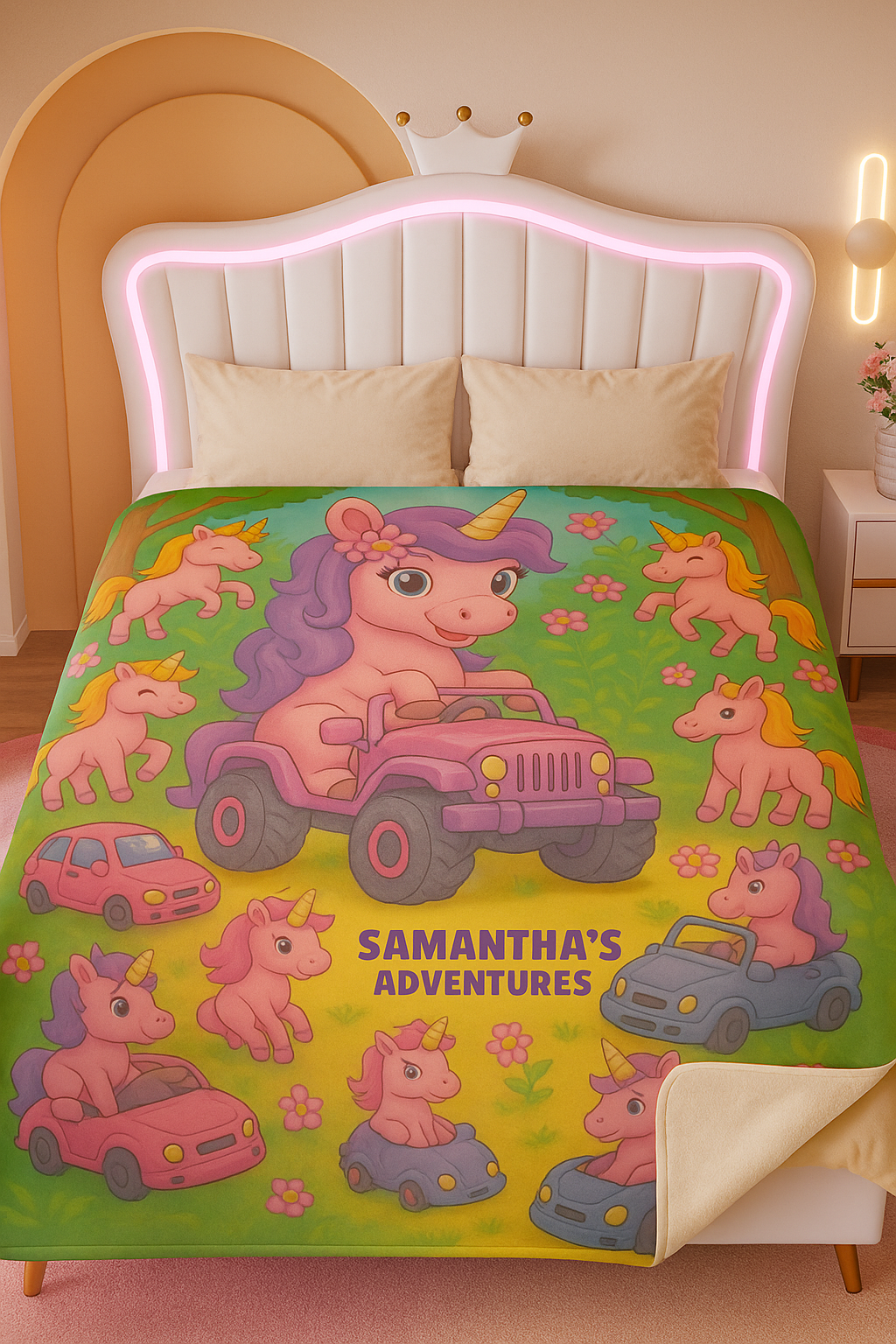 Children's 60x80" blanket with cartoon unicorns and vehicles in a jungle setting, featuring personalization of 'Samantha's Adventures' written on it. The blanket has a corner folded back showing sherpa fleece on the reverse side and is displayed on a queen bed in a child's room.