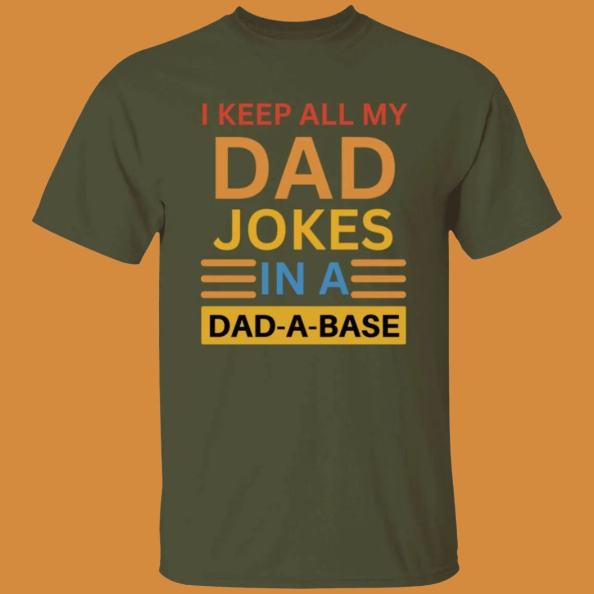 Military green, heavyweight classic unisex t-shirt in 100% cotton. On the front is printed: I keep all my DAD jokes in a DAD-A-BASE - Any Gift For You