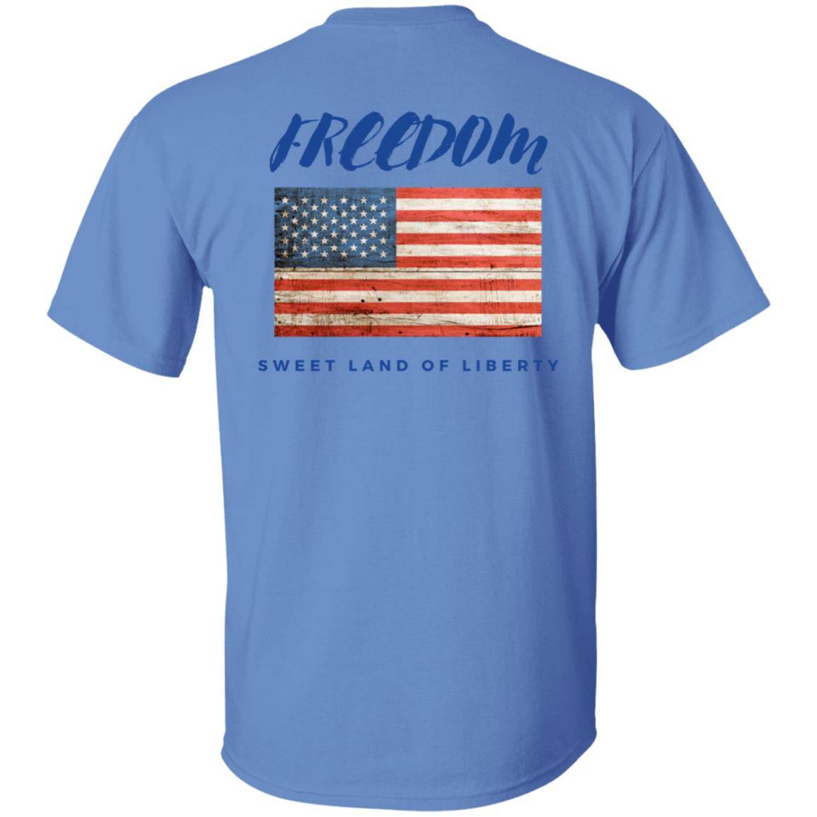 Carolina blue, heavyweight classic unisex t-shirt in 100% cotton. Freedom is written across the chest back with a grunge American flag below it and written beneath that is Sweet Land of Liberty.