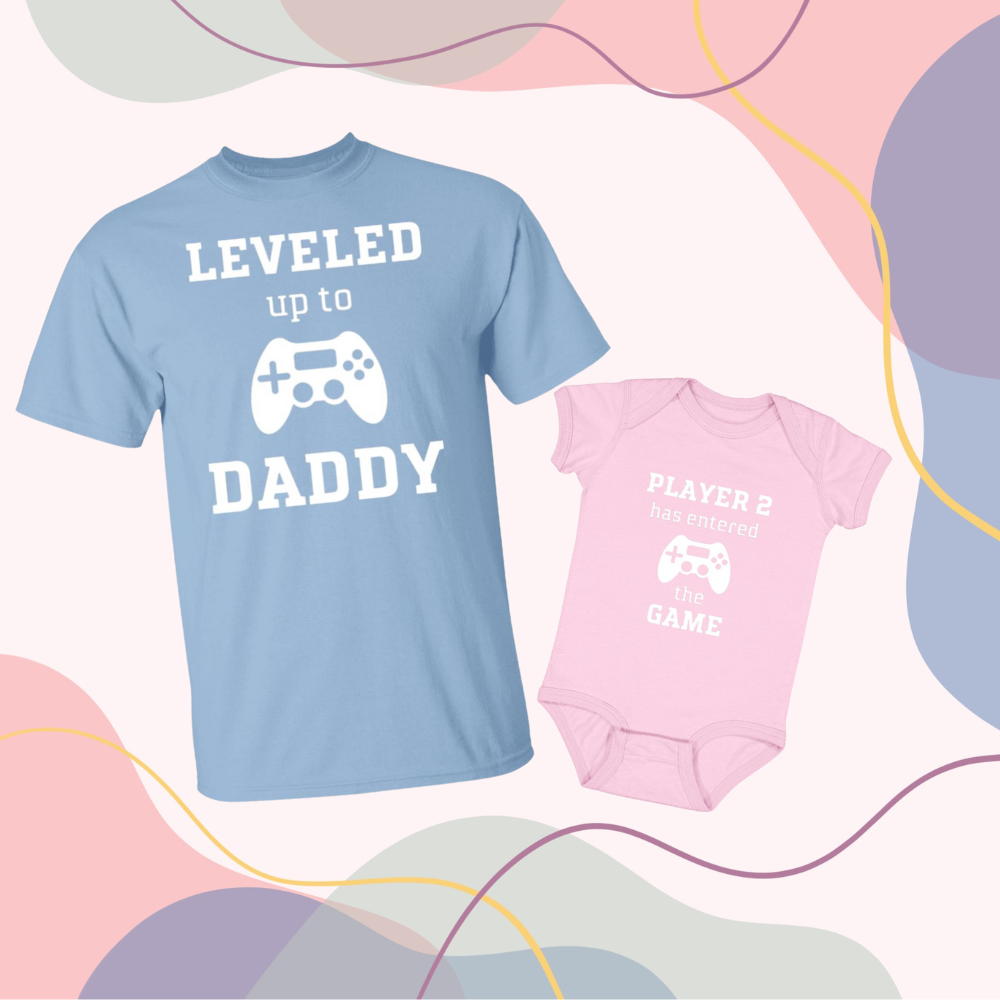 Leveled Up Daddy (in light blue) and Player 2 Infant Body Suit (in pink)